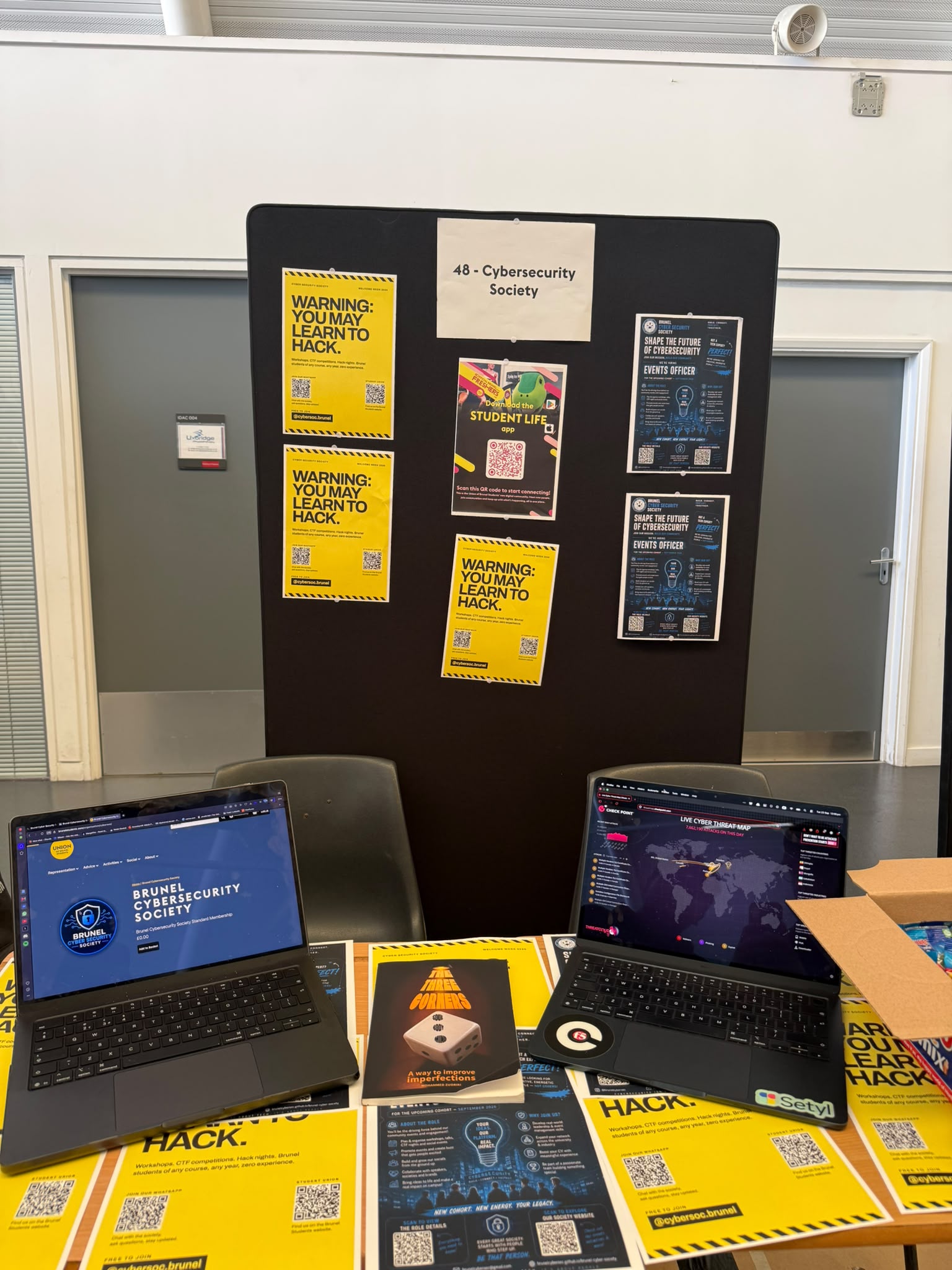 Brunel Cyber Security Society display board and laptops at Freshers